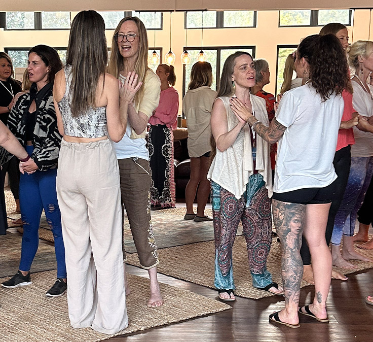 Students practising somatic coaching together in a live training room